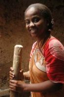 Young mother grinds maize, Lamu